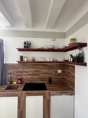 a kitchen with a sink and a wooden counter top at Ca' Zen in Sal Rei