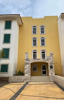a yellow building with windows and a balcony at Realeza in Santa Maria