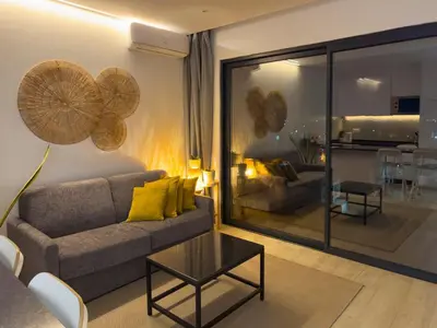 a living room with a couch and a table at 2 bdr aprt, stunning view, rooftop pool - LCGR in Praia