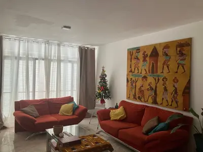 a living room with two red couches and a christmas tree at AkyaSpot in Praia