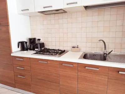 a kitchen with a sink and a stove at Apart T2 em frente à Praia - Centro de Santa Maria in Santa Maria