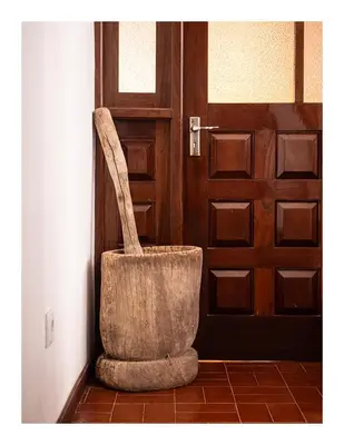 a chair sitting in front of a door at Casa Evora - Your home away from home in Mindelo