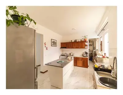 a kitchen with a refrigerator and a counter top at Casa Evora - Your home away from home in Mindelo