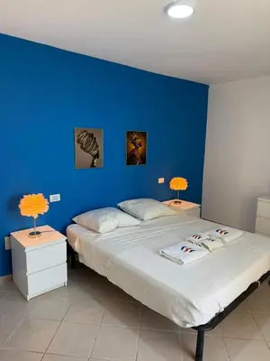 a blue bedroom with two beds with blue walls at Estrela do Sul Santa Maria by RPG Group in Santa Maria