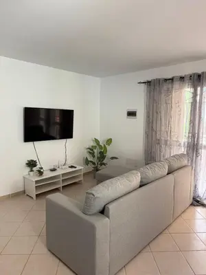 a living room with a couch and a flat screen tv at Estrela do Sul Santa Maria by RPG Group in Santa Maria
