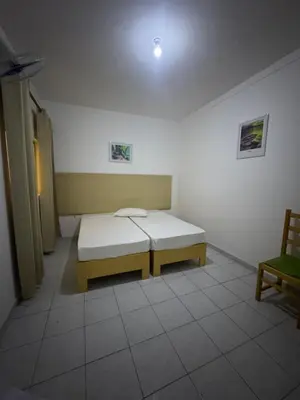 a room with a bed and a bench in it at Legacy cv in Praia