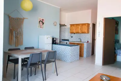 a kitchen with a table and chairs in a room at aparthotelboavista-net in Sal Rei