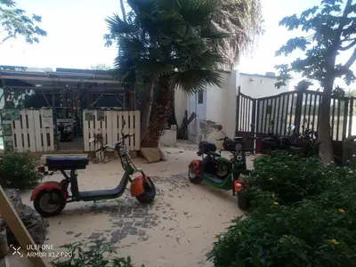 a group of scooters parked next to a house at aparthotelboavista-net in Sal Rei