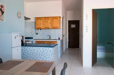 a kitchen with a sink and a refrigerator at aparthotelboavista-net in Sal Rei
