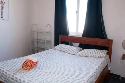 a bedroom with a bed with a blue comforter at aparthotelboavista-net in Sal Rei
