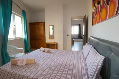 a bedroom with a bed with two towels on it at aparthotelboavista-net in Sal Rei