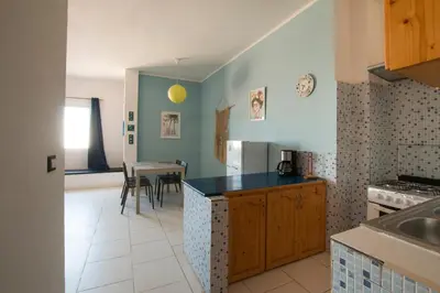 a kitchen with a counter and a table in it at aparthotelboavista-net in Sal Rei