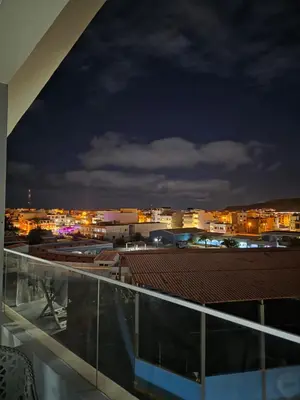 a view of a city at night from a building at The Zen Den in Sal Rei