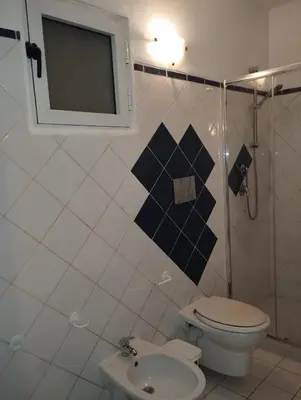 a bathroom with a toilet and a shower at Holiday Properties Ca' Meli - Wi-fi in Santa Maria