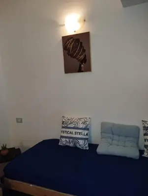 a bedroom with a bed with a blue comforter at Holiday Properties Ca' Meli - Wi-fi in Santa Maria