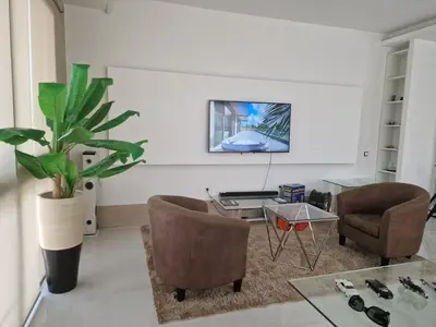 a living room with a glass table and chairs at CV Edifício Vitória, RC Centro - PALMAREJO BAIXO in Praia