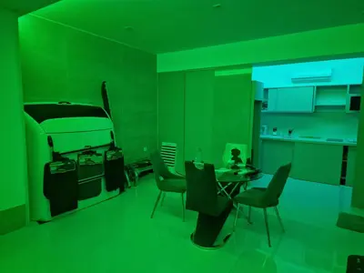 a green room with a kitchen with a table and chairs at CV Edifício Vitória, RC Centro - PALMAREJO BAIXO in Praia