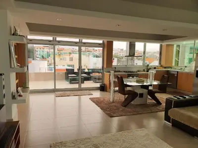 a kitchen and living room with a table and chairs at C Varela C - Casa Branca in Praia