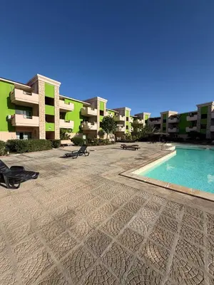 a swimming pool in front of some apartment buildings at HostySpot - Bloco Verde in Santa Maria