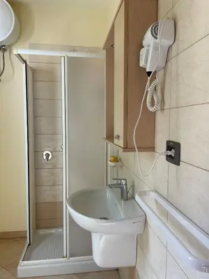 a bathroom with a shower and a toilet and a sink at Central Santa Maria Sea view 2 Bedroomed Apartment in Santa Maria