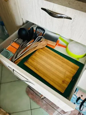 a drawer filled with kitchen utensils and a cutting board at Santa Maria, 4min to Beach - Pool, AC, WiFi, De'Longhi coffee maker in Santa Maria