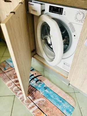 a washer and dryer sitting in a kitchen at Santa Maria, 4min to Beach - Pool, AC, WiFi, De'Longhi coffee maker in Santa Maria