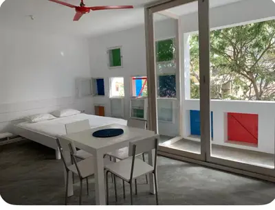 a bedroom with a bed and a table and chairs at Modern&Central Mindelo - 2A in Mindelo