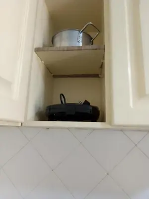 a black briefcase sitting inside of a kitchen cabinet at Ca' Dolce Vita in Santa Maria