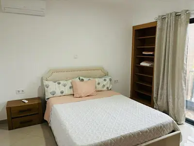 a bedroom with a bed and a dresser and a window at Holiday AP TF 2 in Praia