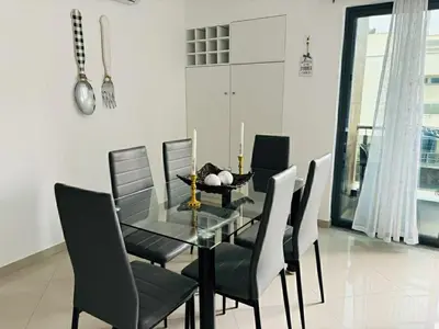 a dining room with a glass table and chairs at Holiday AP TF 2 in Praia