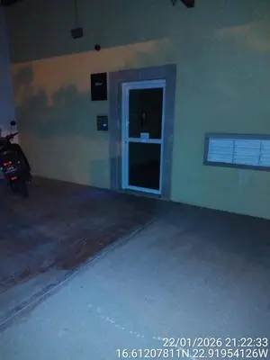 a empty garage with a door and a motorcycle in it at Mb HOUSE VILA VERDE RESORT in Prainha