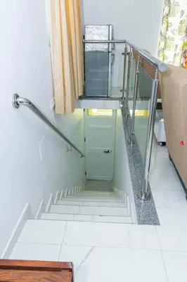 a stairway with a glass door and a stair case at Hospedaria Santo António in Praia Baixo
