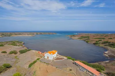 an aerial view of a house on a island in the water at Hospedaria Santo António in Praia Baixo