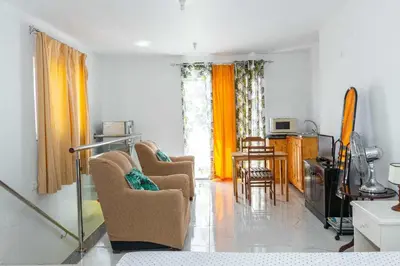 a living room with two chairs and a television at Hospedaria Santo António