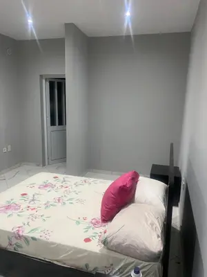 a bed with a pink pillow on it in a room at Campo do campo ocean view in São Filipe
