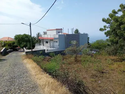 a house sitting on top of a hill next to a road at Campo do campo ocean view in São Filipe