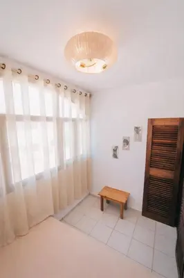 a room with a table and a chandelier at Maluhia Home - Maio in Calheta Do Maio