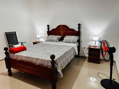 a bedroom with a large bed and two night stands at Villa Esperança in Tarrafal