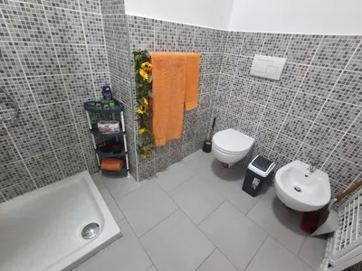 a bathroom with a white toilet and a sink at Apartamento Estoril in Sal Rei