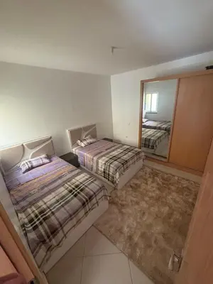 a bedroom with two beds and a large mirror at La casa de iman in Praia