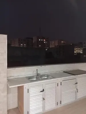 a bathroom counter with a sink and a window at T&S Guest House in Praia