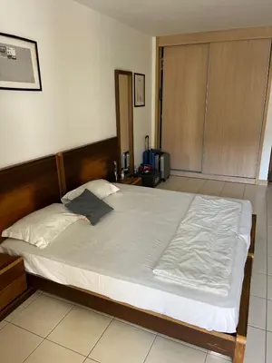 a bedroom with a large bed with white sheets at Vila Verde cozy studio in Prainha