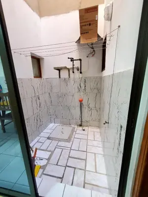 a bathroom being remodeled with a tile floor and pipes at Comfort T2 in Espargos