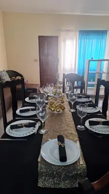 a long table with wine glasses and plates on it at Diva Apartamento in Praia
