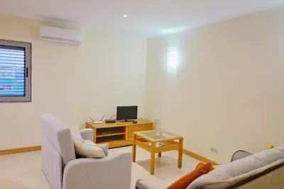 a living room with two couches and a tv at Private Apartament Celestina & Carlos in Mindelo