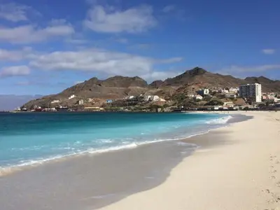 a beach with the ocean and mountains in the background at Private Apartament Celestina & Carlos in Mindelo