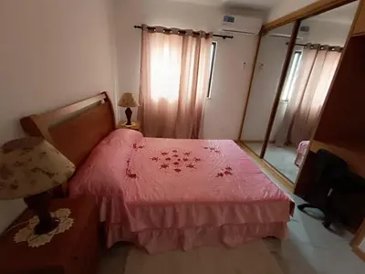 a bedroom with a bed with a pink bedspread at Apartament in Praia in Praia