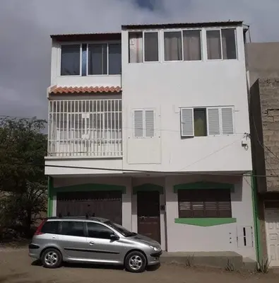 a silver car parked in front of a white building at Chez Zuzu in Mindelo