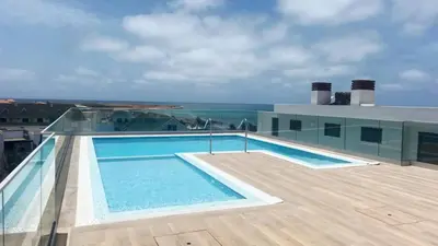 a swimming pool on the roof of a building at Luxury Lux Studio with Seaview in Santa Maria