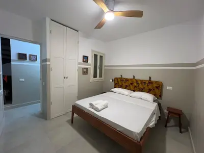 a bedroom with a bed with a ceiling fan at Extraordinary sea view in Sal Rei